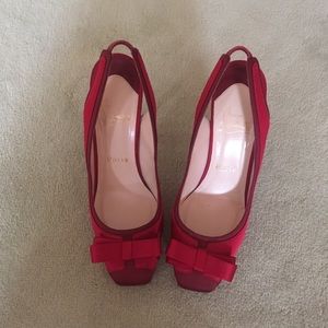 Red satin Louboutin bow-tie stilettos.